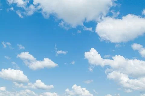 Blue sky with cumulus clouds at daytime. Natural panoramic background photo t Stock Photos