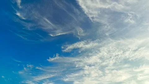 The blue sky is decorated with dense clouds that spread out on a sunny day... Stock Photos