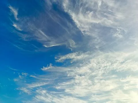 The blue sky is decorated with dense clouds that spread out on a sunny day... Stock Photos