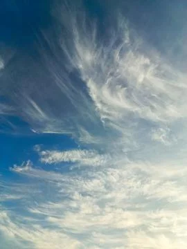 The blue sky is decorated with dense clouds that spread out on a sunny day... Stock Photos