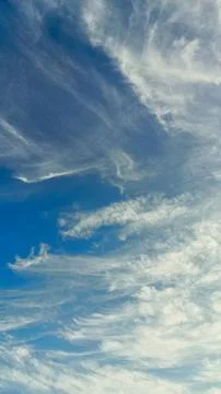 The blue sky is decorated with dense clouds that spread out on a sunny day... Stock Photos