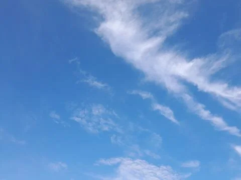 The blue sky decorated with thin white clouds forms an abstract object 스톡 사진