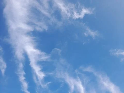 The blue sky decorated with thin white clouds forms an abstract object 写真素材