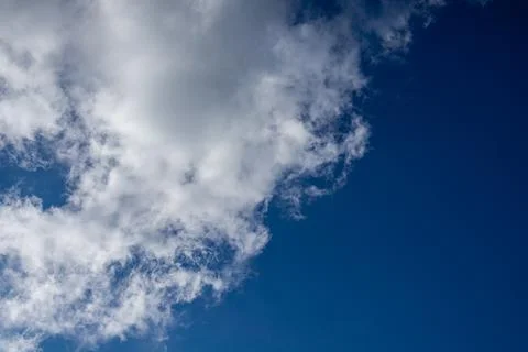 Blue sky with diagonal cloud formation. Stock Photos