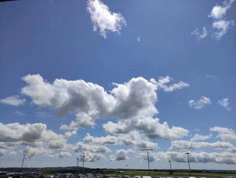 Blue sky with dramatic clouds over open landscape Stock Photos