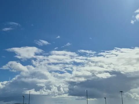 Blue sky with dramatic clouds over open outdoor area Stock Photos