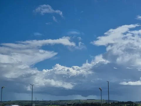 Blue sky with dramatic clouds over rural countryside landscape Photos