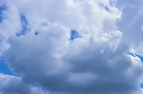 Blue sky with dramatic gray clouds. Stock Photos