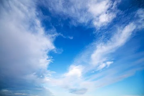 Blue sky with dramatic white clouds Stock Photos