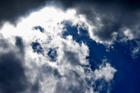 The blue sky dramatically turns into heavy black clouds. 스톡 사진