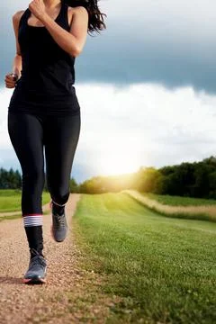 Blue sky, exercise and running and woman in countryside for commitment to c.. Stock Photos