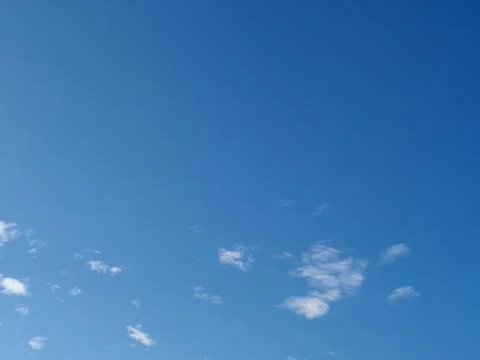 Blue sky with a few clouds background Stock Photos
