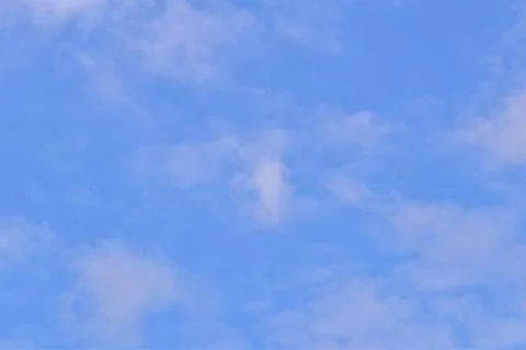 Blue sky with a few white clouds Stock Photos