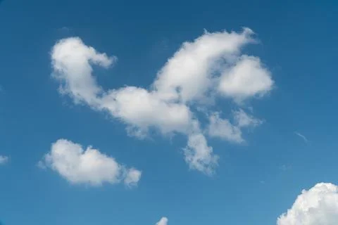Blue sky with a few white patchy clouds Stock Photos