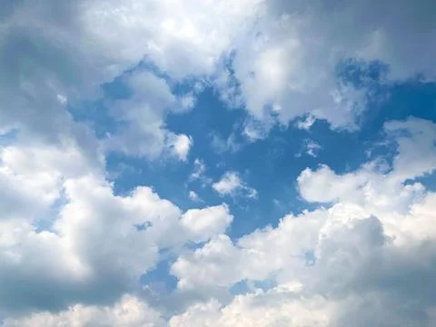 Blue Sky Filled With Fluffy White Cumulus Clouds On A Bright Sunny Day Stock Photos