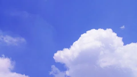Blue sky filled with soft white clouds on a bright clear day (timelaps) Stock Footage 331367174