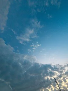 Blue Sky With Fluffy Clouds and Sunset Light Stock Photos