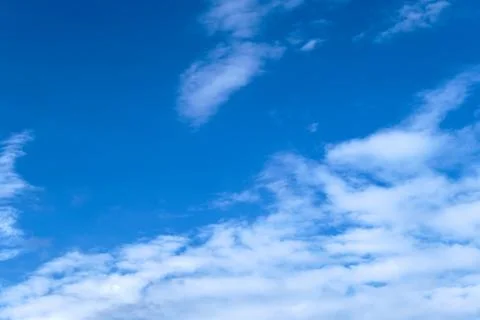 Blue sky with fluffy clouds with copy space. Heaven in a sunny day. Wallpaper Stock Photos