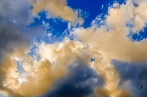 Blue sky with fluffy colored clouds, ray of lights, sunset, dawn Stock Photos