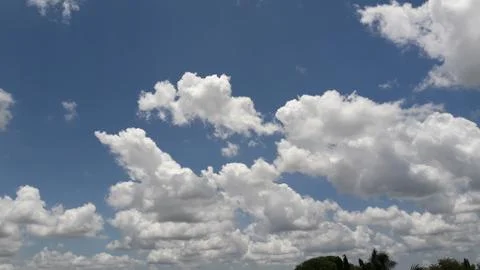Blue sky with fluffy white clouds Stock Photos