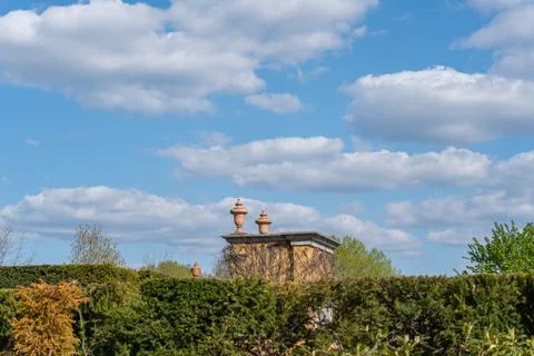 Blue sky with fluffy white clouds above a stone roof Fotos Stock