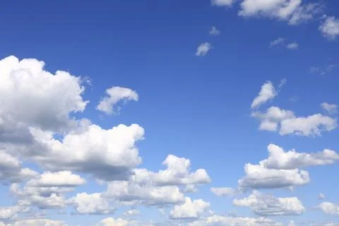 Blue sky with fluffy white clouds background Stock Photos