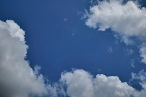 Blue Sky with Fluffy White Clouds Stock Photos