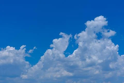 Blue sky with fluffy white clouds Stock Photos