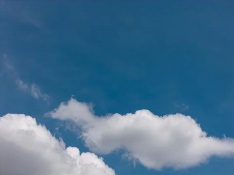 Blue sky with fluffy white clouds overhead 스톡 사진