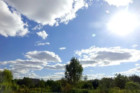 Blue Sky With Fluffy White Clouds Over a Vibrant Countryside Landscape Duri.. Stock Photos