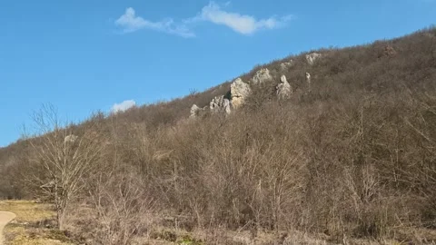 Blue sky frames a rocky hillside. Mount Rtanj Area, Serbia Vidéo 331279572
