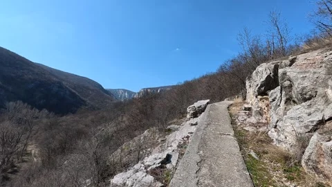Blue sky frames a rugged valley. Balkan, Eastern Europe, POV Video stock 331430621