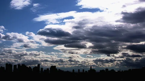 Blue Sky with Heavy Clouds Timelapse over City Skyline GT2221 Stock Footage 163843925