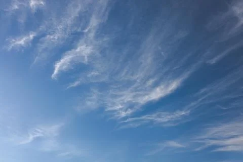 Blue sky with high cirrus clouds forming wispy patterns Stock Photos