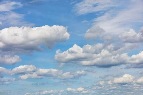 Blue sky landscape with white floating clouds. Stock Photos