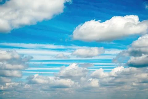 Blue sky with layered white clouds and horizontal striped cloud pattern ove.. Stock Photos