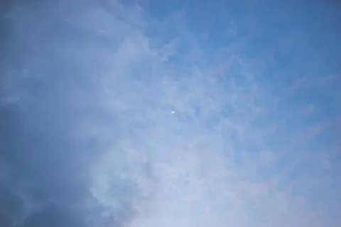 Blue sky with light clouds and moon. Beautiful sky. Scenic view in evening Stock Photos