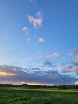 Blue sky with light clouds over the field Stock Photos
