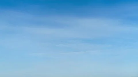 Blue sky with light soft clouds, time lapse. Clear day atmosphere with brig.. Stock Photos