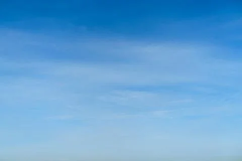 Blue sky with light soft clouds. Clear day atmosphere with bright horizon. Su Photos
