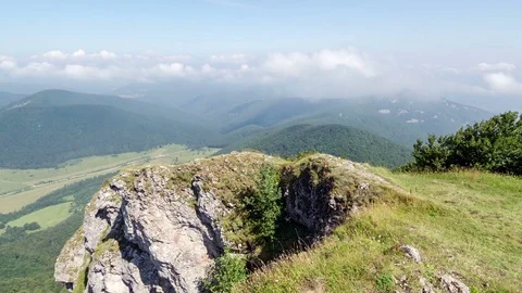Blue sky with low cumulus clouds over landscape with rocks time lapse Stock Footage 70963212