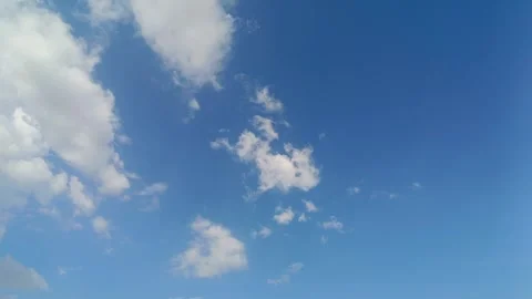 Blue sky with moving white clouds in time-lapse, horizontal skyscape Stock Footage 308638800
