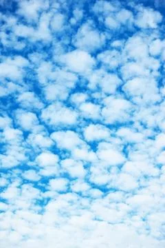 Blue sky with multitude of white clouds Stock Photos