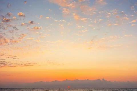 Blue sky with orange clouds Stock Photos