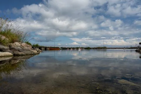 A blue sky with patchy clouds over a calm bay in summertime. From the swedish Stock Photos