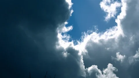 Blue sky peaking through dramatic storm clouds Stock Footage 126058994