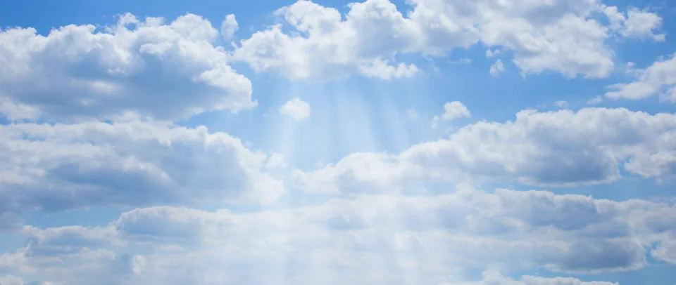 Blue sky with rays. Beautiful cloudy sky Stock Photos
