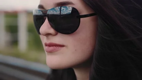 The blue sky is reflected in the glasses of the beautiful girl Stock Footage 201969319