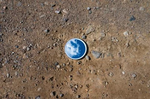 Blue sky reflected in the mirror breaking up on dry soils. Climate change c.. Stock Photos