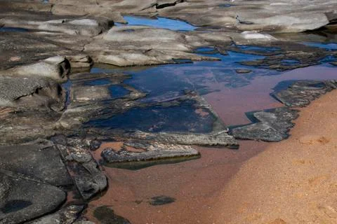 Blue sky reflected in rock pools at seaside Stock Photos
